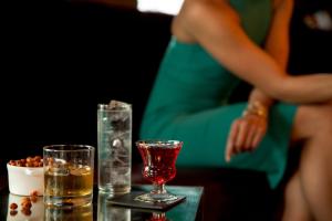 a table with two glasses and a bowl of nuts at Kimpton Palladian Hotel by IHG in Seattle