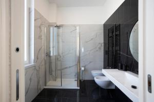 a bathroom with a shower and a toilet and a sink at SINONDA Luxury Apartment in Maiori +26 photos