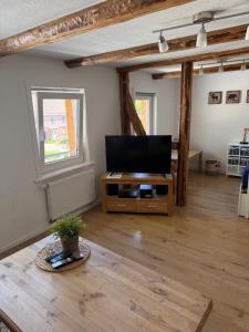 a living room with a flat screen tv on a table at Ferienwohnung im Hooptal in Negenborn