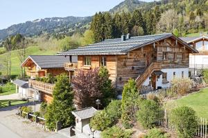 an aerial view of a log home with a mountain at Chalet-F in Ofterschwang