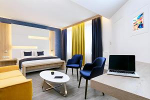 a hotel room with a bed and a laptop on a desk at KVi Hotel Budapest - the smart hotel in Budapest