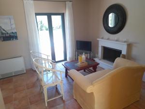 a living room with a couch and a table at Private Pool Villas in Svoronata