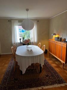 a dining room with a white table and chairs at Spacious house in cozy Kristdala in Kristdala +14 photos