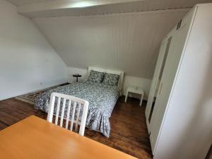 a small bedroom with a bed and a table at La Chambre Claire in Strasbourg +7 photos