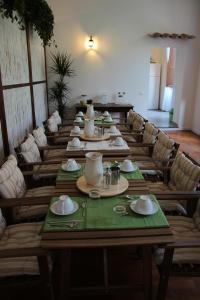 a long dining room with a long table and chairs at B&B Gallidoro in Palermo