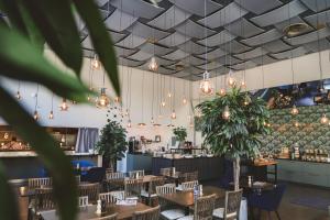 a restaurant with tables and chairs and lights at Quality Hotel Galaxen in Borlänge