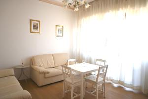 a living room with a couch and a table and chairs at SE268 - Marzocca, comodo quadrilocale con garage in Marzocca di Senigallia