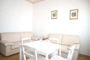 a living room with a white table and a couch at SE268 - Marzocca, comodo quadrilocale con garage in Marzocca di Senigallia