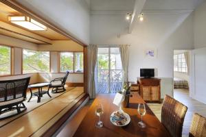 a living room with a table and chairs at Resort Villa Takayama in Takayama