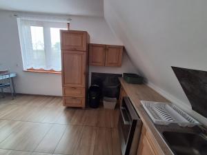 a kitchen with wooden cabinets and a stove in a room at Monteurzimmer KM in Delbrück