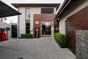 a entrance to a building with a brick wall at Sasavona Boutique Hotel in Polokwane