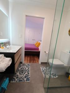 a bathroom with a sink and a toilet and a tub at Private Cozy Sleepout with Free Parking & Self Check-in in Hamilton