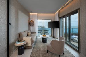 a living room with a couch and a table at Leonardo Plaza Haifa in Haifa