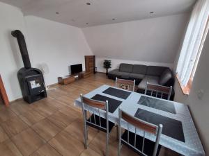 a living room with a table and a fireplace at Monteurzimmer KM in Delbrück