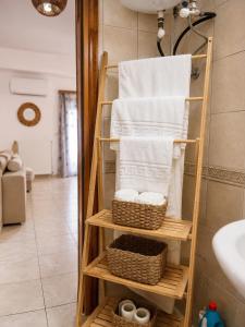 a towel rack with towels on it in a bathroom at Indaba Luxury Apartments in Myrina