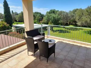 a patio with chairs and a table on a balcony at Private Pool Villas in Svoronata