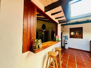 a kitchen with a counter and stools in a room at Posada Santa Lucía de Cucaita in Cucaita
