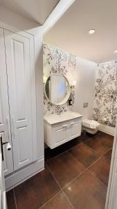 a bathroom with a sink and a mirror at Çeşme Seaside House in Çeşme +13 photos