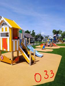 a playground with a slide in a park at Mobil'home Valras in Valras-Plage