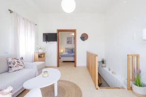 a living room with a couch and a table at Thalassini in Daratso