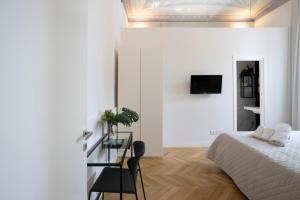 a bedroom with a bed and a table and a chair at SINONDA Luxury Apartment in Maiori