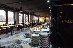 a restaurant with stacks of plates on a table at Mari Kiri Penzion in Bratislava