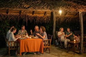 a group of people sitting at a table eating at WildEscape, Yala Blocks 3, 4 & 5 in Buttala