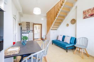 a living room with a table and a blue couch at Thalassini in Daratso
