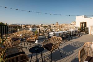 a group of chairs and tables on a balcony at Nivia Born Boutique Hotel in Palma de Mallorca