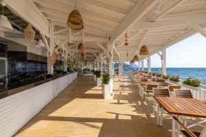 a seafood restaurant on the beach with tables and chairs at Crystal Flora Pearl Collection - Ultimate All Inclusive in Beldibi