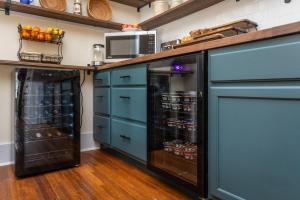 a kitchen with blue cabinets and a refrigerator at The Legacy Inn in Luray