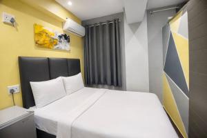 a bedroom with a white bed and a window at Hotel Metro Lodge Xpress in Durban