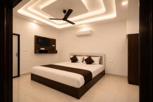 a bedroom with a bed with a ceiling fan at Shree Sita Sadan in Ayodhya