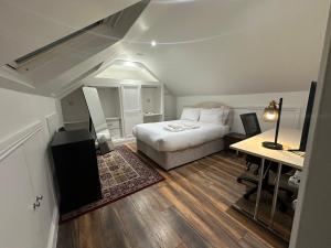 a small bedroom with a bed and a desk and a desk at The View At Alison Avenue in Bristol