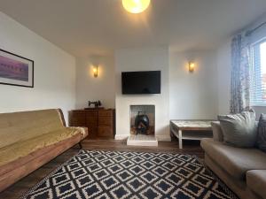 a living room with a bed and a fireplace at The View At Alison Avenue in Bristol