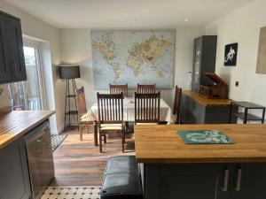 a kitchen with a table and chairs and a map on the wall at The View At Alison Avenue in Bristol
