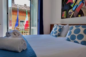 a bedroom with a bed with towels on it at Locanda Milano 1873 in Brunate