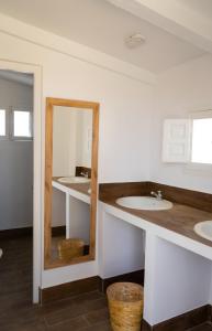 a bathroom with three sinks and a mirror at Cortijo El Solano in Antequera