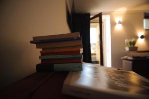 a stack of books sitting on top of a table at Chambres d’hôtes La Latteria in Torgnon +31 photos