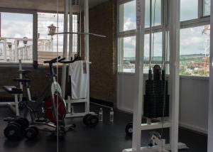 a gym with two exercise bikes in a room with windows at Hotel Latino in Sahuayo de José María Morelos