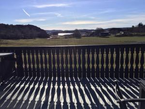 a bench with a view of a golf course at Rösselviks Gård in Rösselvik +31 photos