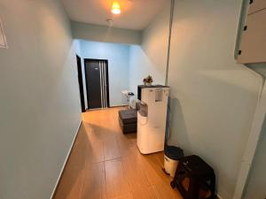 a room with a white refrigerator in a room at Hotel Yasmin in Brinchang