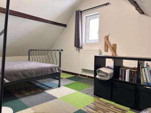 a bedroom with a bed and a book shelf at Ferienhaus Ferienwohnung Petermännchen in Westerburg