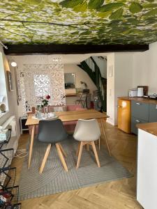 a dining room with a table and two chairs at Ferienhaus Ferienwohnung Petermännchen in Westerburg