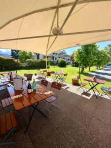 a group of tables and chairs under an umbrella at Campanile Chambéry in Chambéry