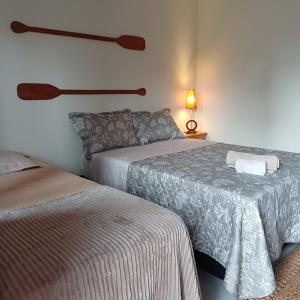 a hotel room with two beds and a lamp at Kite House Lençóis in Santo Amaro +64 photos