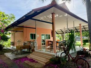 a small house with a blue and white roof at Wandee Resort Bankrut in Ban Krut