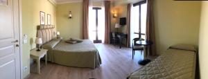 a bedroom with a bed and a couch in a room at Il Parco Sul Mare Resort & SPA in Tortoreto Lido +79 photos