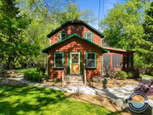 a small red brick house in a yard at Peaceful Lake Como Retreat in Lake Geneva
