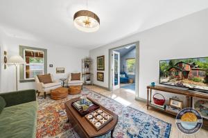 a living room with a couch and a tv at Peaceful Lake Como Retreat in Lake Geneva +27 photos
